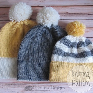 May include: Three knitted hats with pom-poms in different colors and patterns. The hats are yellow and white, gray, and gray and white stripes. The hats are arranged in a row on a wooden surface. Knitting Pattern.