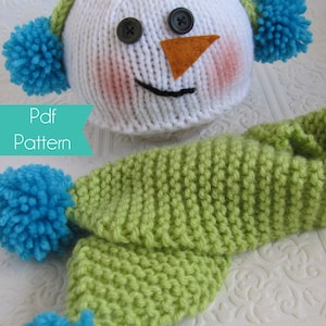 May include: A knitted snowman hat with green and white stripes and blue pom-poms, and a matching green scarf with blue pom-poms. The hat has a felt orange nose and black button eyes. The text "Pdf Pattern" is visible in the image.