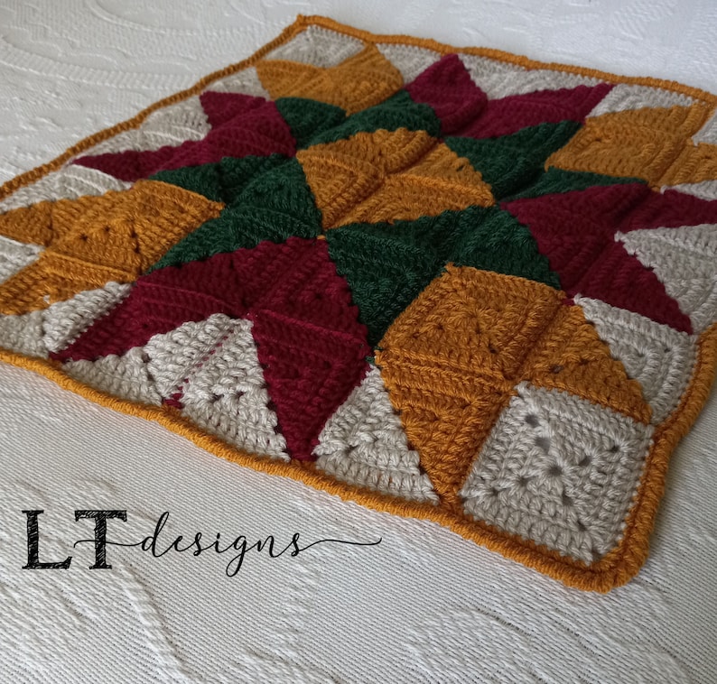 May include: A crocheted throw blanket with a star pattern in shades of red, green, beige, and gold. The blanket is made with a variety of stitches and textures, creating a unique and interesting design.