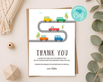 May include: A white thank you card featuring a winding grey road with yellow, green, red, orange, and blue cars. The text reads: THANK YOU, I LOVED THE CAKE AND THE PRESENTS TOO. BUT MY FAVOURITE PART WAS SPENDING TIME WITH YOU. THANKS FOR MAKING MY 2ND BIRTHDAY SO SPECIAL. xoxo Eddie.