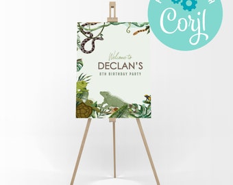 May include: A welcome sign for a birthday party with a jungle theme. The sign features a green iguana, a snake, a turtle, and frogs on a green background with tropical leaves. The text on the sign reads "Welcome to Declan's 8th Birthday Party".