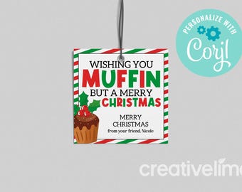 May include: A square Christmas gift tag with a red, green, and white border. The tag reads "Wishing You Muffin But a Merry Christmas" with a cupcake graphic. The tag is strung with a black cord.