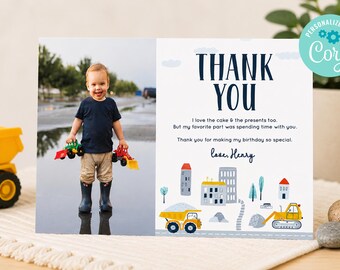 May include: A rectangular thank you card featuring a photo of a child holding toy construction vehicles on the left and text on the right. The text reads: THANK YOU, I love the cake & the presents too. But my favorite part was spending time with you. Thank you for making my birthday so special. love, Henry. Below the text are illustrations of buildings and yellow construction trucks.