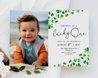 May include: A green shamrock-themed first birthday invitation featuring a photo of a baby boy. The invitation reads "Charlie is a lucky one" and includes the date, time, and location of the party.