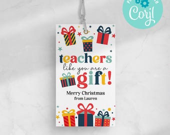 May include: A white gift tag with the text "teachers like you are a gift!" and "Merry Christmas from Lauren." The tag features colourful illustrations of wrapped presents and stars, with a string for hanging.