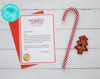 May include: A Christmas-themed flat lay featuring a red envelope with a letter from Santa Claus, a candy cane, and a gingerbread cookie. The letter is decorated with red stripes and the text "Special delivery from Santa Claus".