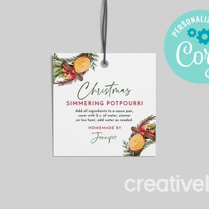 May include: A white gift tag with a watercolour illustration of cinnamon sticks, oranges, and greenery. The text reads "Christmas Simmering Potpourri" and includes instructions for use. The tag is labelled "Homemade by Jennifer".