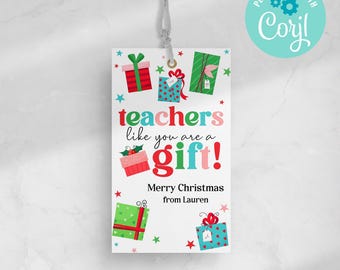 May include: A white gift tag with a gray string, featuring colourful illustrations of wrapped presents and text that reads "teachers like you are a gift!" and "Merry Christmas from Lauren."