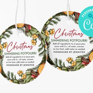 May include: Two round Christmas-themed gift tags featuring a watercolour design of pine branches, berries, cinnamon sticks, and oranges. The text on the tags reads "Christmas Simmering Potpourri" and includes instructions for making the potpourri. The tags are personalised with the name "Coril".