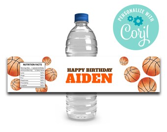 May include: Water bottle label featuring a basketball theme. The label is white with orange text that reads "Happy Birthday Aiden". There are several orange basketballs on the label. The label also includes a nutrition facts table with a humorous list of items such as "Love", "Hugs", and "Friendship".
