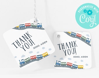 May include: Thank you tags with a train design. The tags are white with blue, red, yellow, and green trains on a track. The text "Thank You!" is in black with the words "XOXO, AIDEN" in smaller black text below.