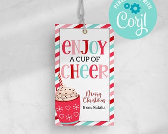 May include: Red and white striped gift tag with the text "Enjoy a cup of cheer" and a red mug with whipped cream and chocolate sprinkles. The text "Merry Christmas from, Natalia" is below the mug.