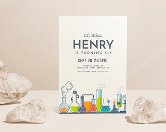 May include: A white invitation card with blue text that reads "Let's Celebrate Henry is turning six Sept 30 2:00PM Henry's Science Lab 1814 Beaker Street Berkeley, CA RSVP to Henry's Mom at 414-311-1596". The card features a colorful illustration of beakers, flasks, and other science lab equipment.