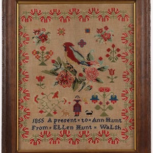 May include: A framed sampler with a bird, flowers, and a small figure in a dress. The sampler is dated 1855 and reads "A present to Ann Hunt from Ellen Hunt Walsh".