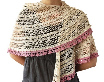 May include: A crocheted shawl with a delicate lace pattern and a pink border. The shawl is made with a cream-colored yarn and has a textured, bobbly effect.