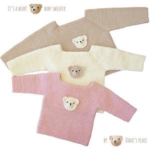 May include: Three knitted baby sweaters with bear appliques. The sweaters are in beige, white, and pink.