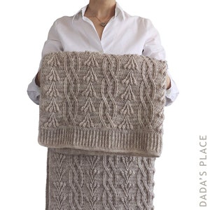 May include: A beige crochet blanket and skirt set with a textured leaf pattern. The blanket is rectangular, and the skirt is a similar design. The set is held up against a white background.