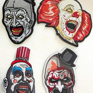 May include: Four embroidered patches featuring scary clown faces. Each patch has a different design, including a clown with red hair, a clown with a top hat, and a clown with a painted face. The patches are in various colors, including red, white, black, and gray.