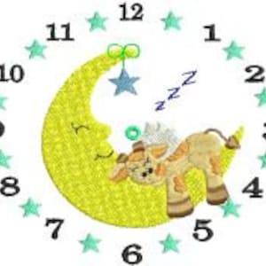 May include: Embroidered clock face featuring a sleeping giraffe on a crescent moon. The moon is yellow, and the giraffe is tan and brown. The clock face has blue stars marking the hours and the numbers 1-12 around the edge.
