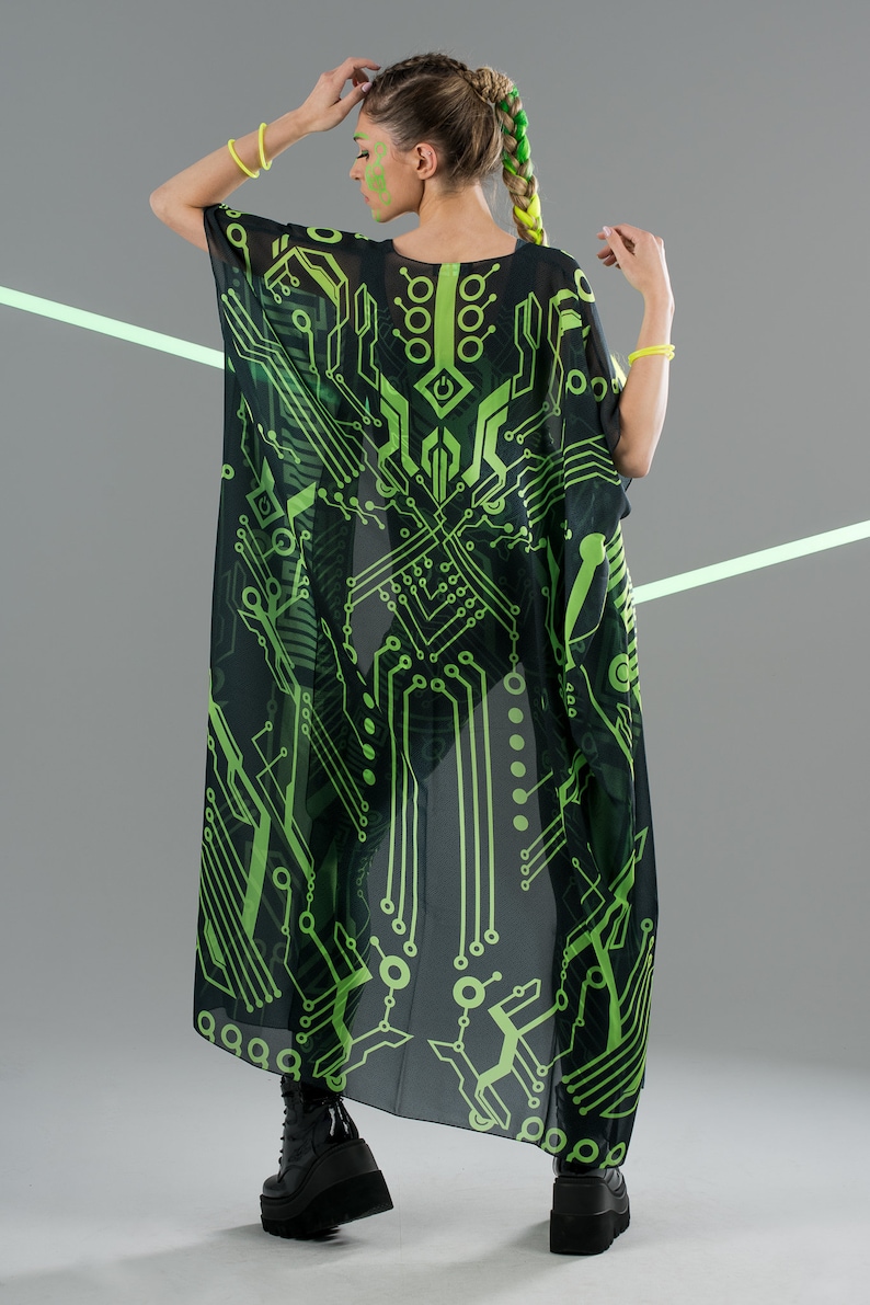 May include: A black sheer kimono with a green circuit board pattern. The kimono is long and flowing, and the pattern is detailed and intricate.