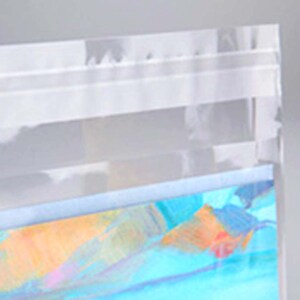 May include: A clear plastic bag with a blue and orange iridescent pattern on the bottom. The bag has a white zipper closure.