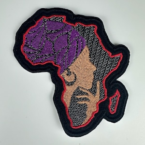 May include: Embroidered patch in the shape of Africa, featuring a profile of a person with purple hair and a brown face. The patch has a black border with a red inner outline.