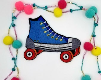 May include: Blue and white roller skate with red wheels. The skate is embroidered and has a white sole and laces.