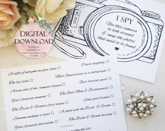 May include: A printable "I Spy" game with a black and white illustration of a camera. The game features a list of wedding-related items to find, such as "The Bride & Groom's first dance" and "The Best Man & Bridesmaids".