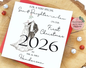 May include: A square white greeting card with black text reading FOR A VERY SPECIAL Son & Daughter-in-law ON OUR First Christmas 2026 AS MR & MRS Henderson. The card features a watercolor illustration of a wedding dress and tuxedo.
