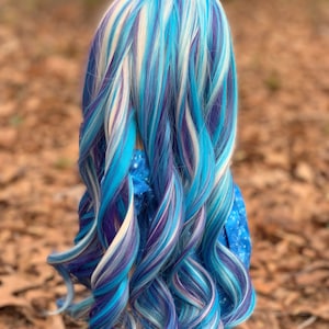 May include: A long, curly wig with streaks of blue, purple, and white.