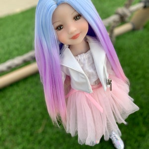 May include: A doll with long, ombre hair that transitions from light blue to purple. She is wearing a white jacket, a pink tulle skirt, and white shoes.