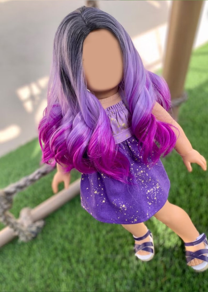 May include: A doll with long, wavy hair that transitions from gray to purple and then to a vibrant magenta. The doll wears a purple dress with gold speckles and matching sandals.