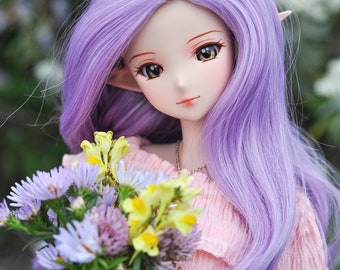 May include: A doll with long, purple hair and a pink top holds a bouquet of purple, yellow, and white flowers.