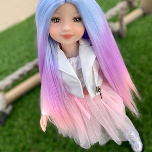 May include: A doll with long, ombre hair that transitions from light blue to purple to pink. She is wearing a white jacket and a pink tulle skirt.