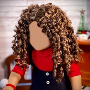 May include: A doll with long, curly brown hair wearing a red turtleneck sweater and a black overall dress with white buttons.