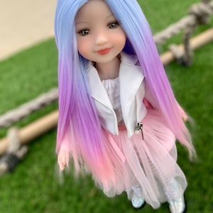 May include: A doll with long, ombre hair that transitions from light blue to purple to pink. She is wearing a white leather jacket, a pink tulle skirt, and white boots.