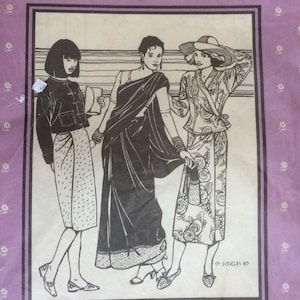 May include: A sewing pattern for South Asian tops and wraps, featuring three women wearing different styles: a Burmese jacket, a Thai blouse, an Indian choli, and sarong skirts and saris. The pattern is from Folkwear, Shields 85.