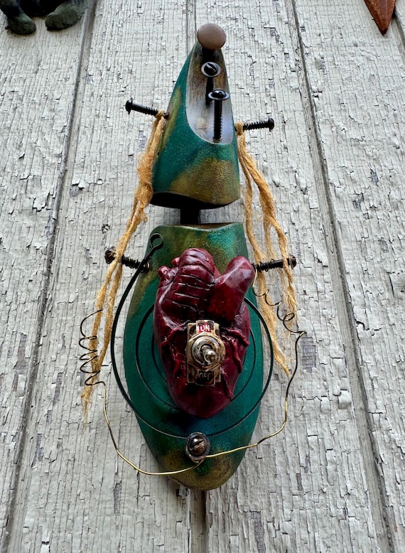 A vintage cobbler's shoe last transformed into a steampunk sculpture with a hand-sculpted anatomical heart — the kind of weird, wonderful object that stops guests in their tracks.