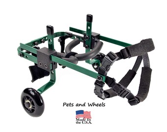 May include: Green metal dog wheelchair with black wheels and adjustable straps.  "Pets and Wheels" and "Made in the U.S.A." are printed on the bottom of the image.