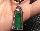 Natural green jadeite inlaid with a stylish and beautiful necklace pendant in 925 silver.