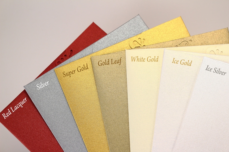 May include: A close-up of eight different colored cardstock samples. The colors are red lacquer, silver, super gold, gold leaf, white gold, ice gold, and ice silver.