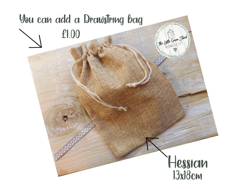 May include: A brown drawstring bag made of hessian fabric. The bag is 13 inches by 18 inches and is sitting on a wooden surface. The text "You can add a Drawstring bag &pound;1.00" is visible above the bag.