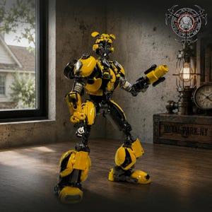 May include: A yellow and black robot figurine constructed from metal parts. The robot features a rounded head with antennae, a segmented torso, and articulated limbs. One arm is extended, holding a cylindrical weapon component. The design incorporates automotive-inspired plating and mechanical joints throughout the structure.