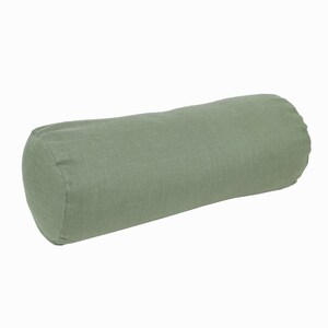 May include: A green cylindrical pillow made of linen fabric.