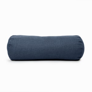 May include: A blue cylindrical cushion made from a textured fabric. The cushion is perfect for adding a touch of comfort and style to any room.