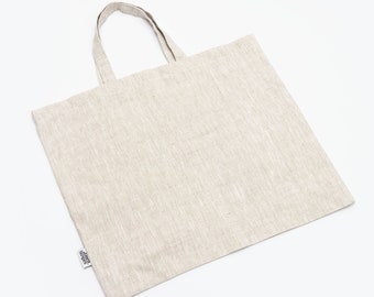 May include: A natural linen tote bag with a simple design and a small label that reads "Linen Supply".