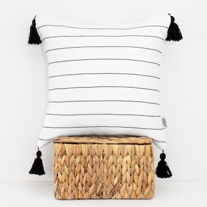 Capa de almofada em linho com riscas pretas e brancas e borlas pretas. Fronha Boho. Capa de almofada moderna escandinava. Simulação de linho orgânico. Presente.