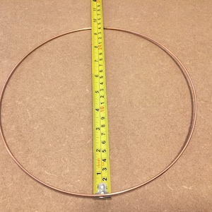 May include: A copper wire circle measuring 10 inches in diameter.