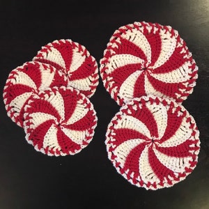 May include: Four crocheted red and white peppermint candy-shaped coasters.