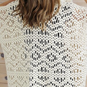 May include: A crocheted top with a delicate openwork pattern in a cream color.